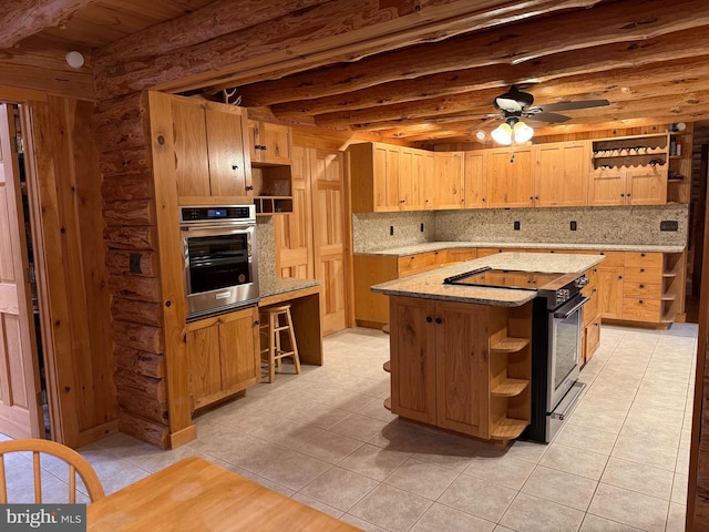 kitchen with a center island, ceiling fan, decorative backsplash, light tile patterned floors, and stainless steel appliances