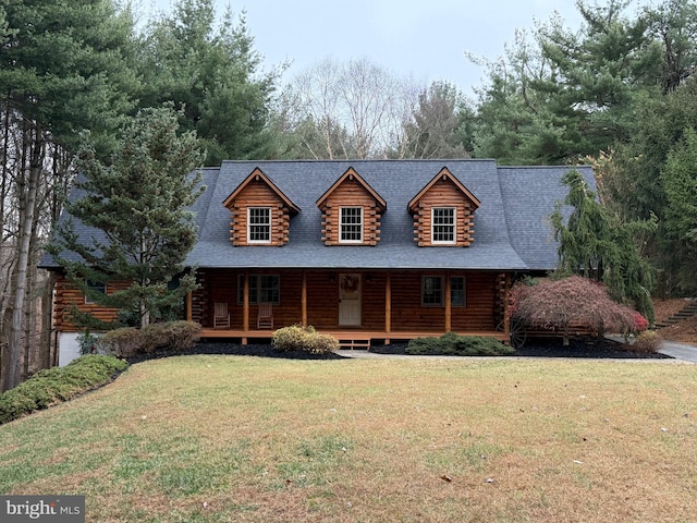 log cabin featuring a porch and a front yard