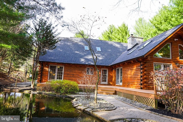 back of property with a wooden deck