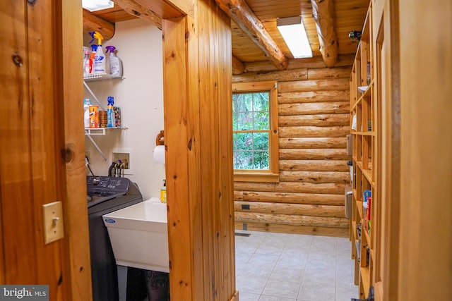 washroom featuring hookup for a washing machine, light tile patterned flooring, wooden ceiling, and log walls