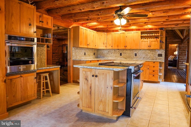 kitchen featuring beam ceiling, a center island, light tile patterned floors, and stainless steel appliances