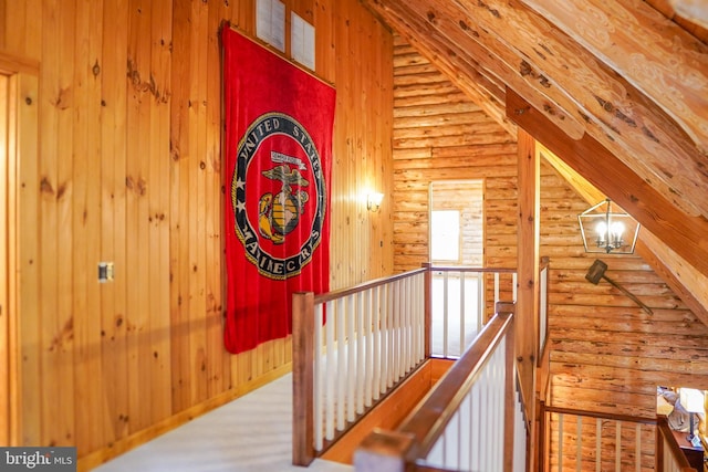 corridor featuring hardwood / wood-style flooring, a chandelier, and vaulted ceiling