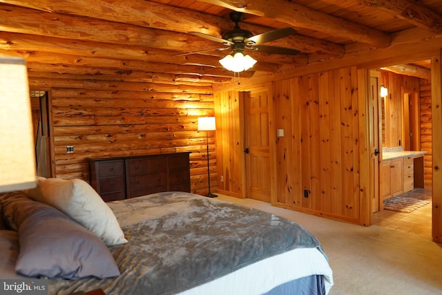 carpeted bedroom with ceiling fan, rustic walls, connected bathroom, beam ceiling, and wood ceiling