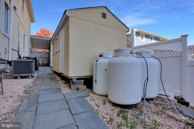 view of side of home featuring central AC