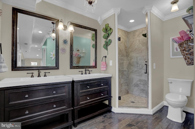 bathroom with an enclosed shower, toilet, vanity, crown molding, and hardwood / wood-style flooring