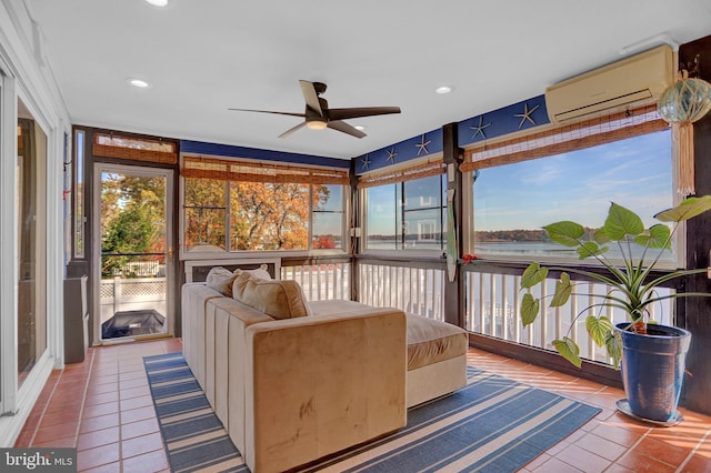 sunroom featuring a wall mounted AC and ceiling fan