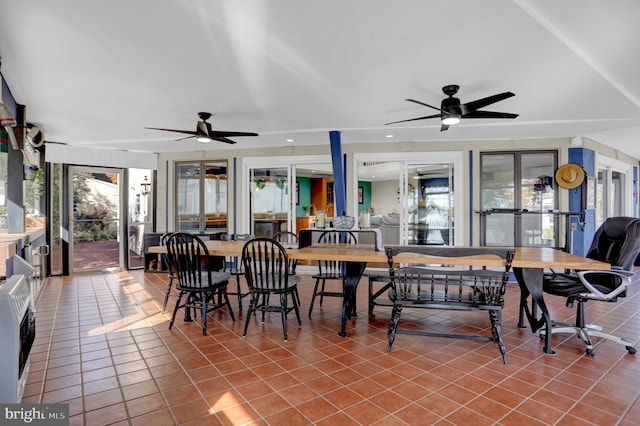 dining space featuring ceiling fan, heating unit, and tile patterned flooring