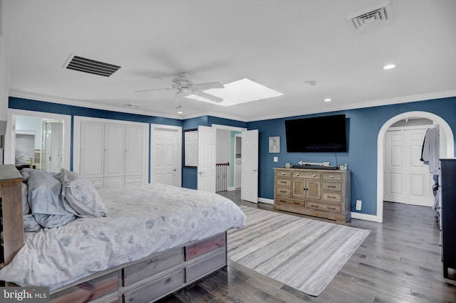 bedroom with crown molding, wood-type flooring, and ceiling fan