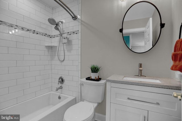 full bathroom featuring toilet, tiled shower / bath combo, and vanity