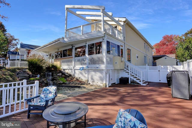 exterior space featuring a patio area, an outdoor fire pit, and a deck