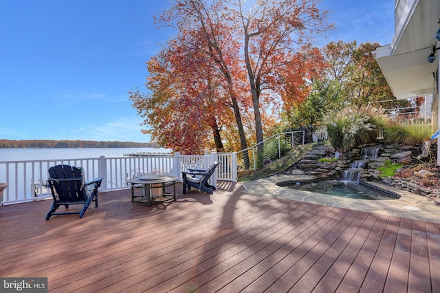 wooden terrace featuring a water view