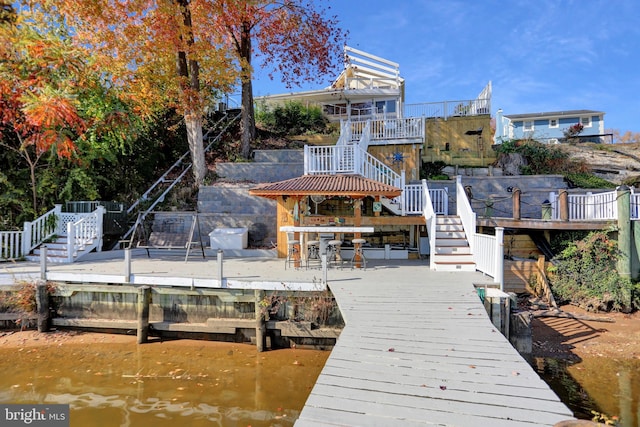 view of dock featuring a deck with water view