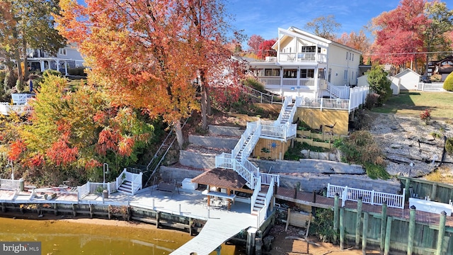 rear view of property with a deck with water view