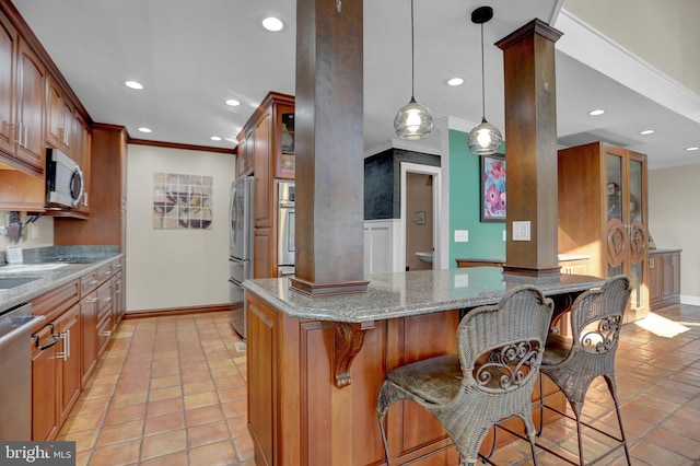 kitchen with stainless steel appliances, light stone countertops, a kitchen bar, pendant lighting, and light tile patterned flooring