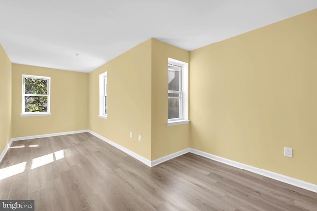 unfurnished room with light hardwood / wood-style flooring