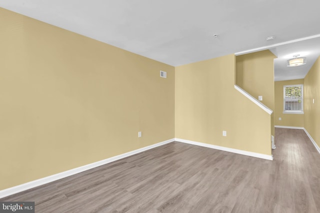 unfurnished room with light wood-type flooring