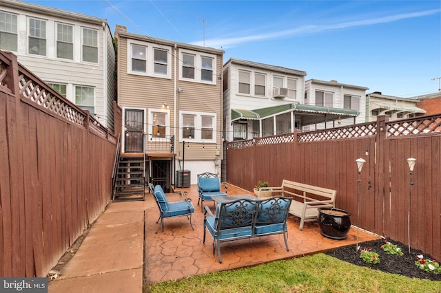 back of house featuring a patio area and an outdoor living space