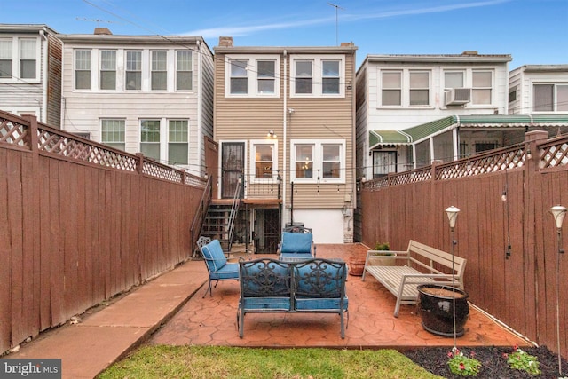 rear view of property with a patio, an outdoor hangout area, and cooling unit