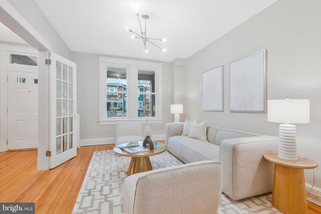 living room featuring a notable chandelier and light hardwood / wood-style floors