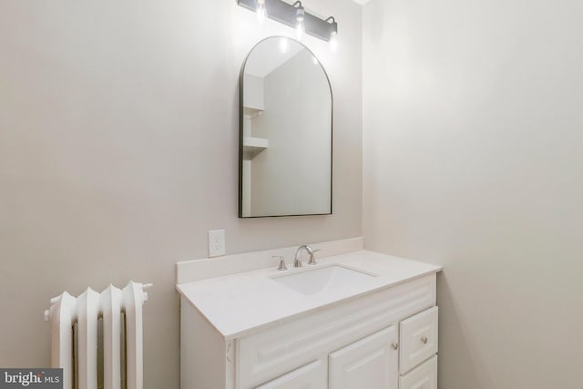 bathroom with vanity and radiator