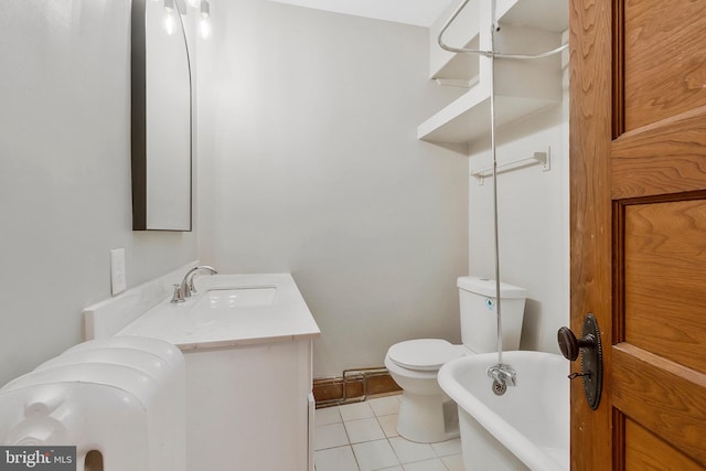 bathroom featuring tile patterned flooring, vanity, toilet, and a bathing tub