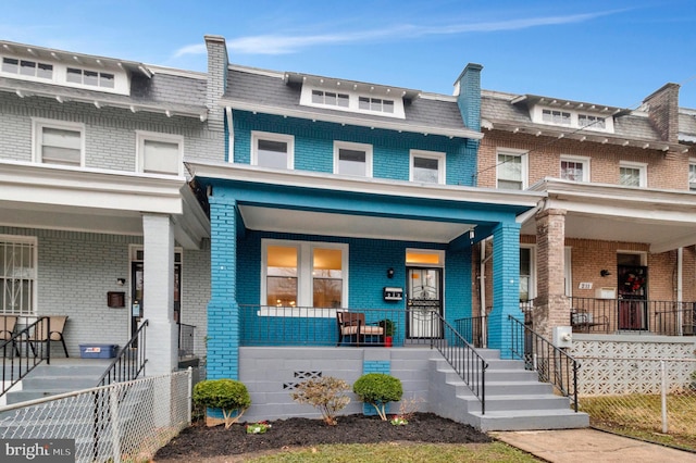 213 Channing St NE, Washington, DC 20002 - townhome / multi-family property featuring covered porch, mansard roof, and brick siding