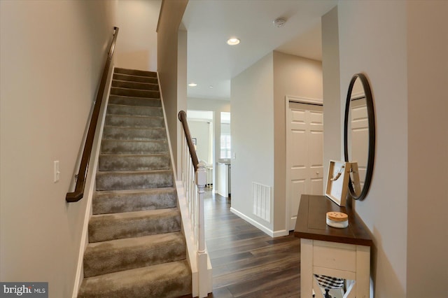 stairway featuring wood-type flooring