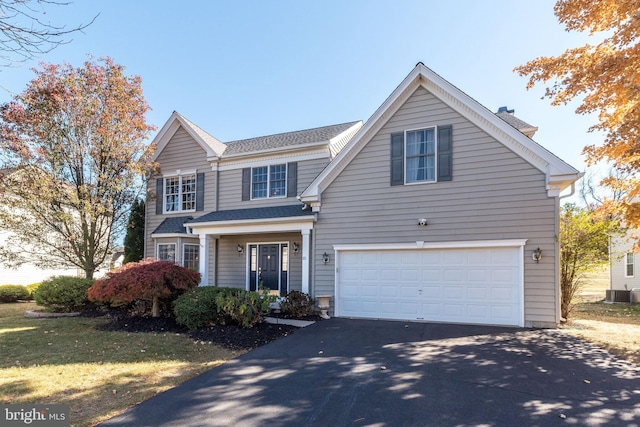 front of property with a garage and cooling unit