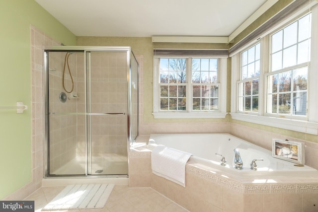 bathroom featuring tile patterned flooring, a healthy amount of sunlight, and shower with separate bathtub