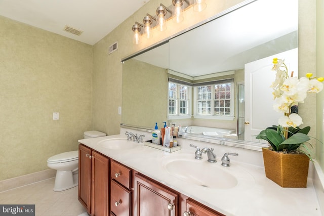 bathroom featuring vanity, toilet, tile patterned floors, and a washtub