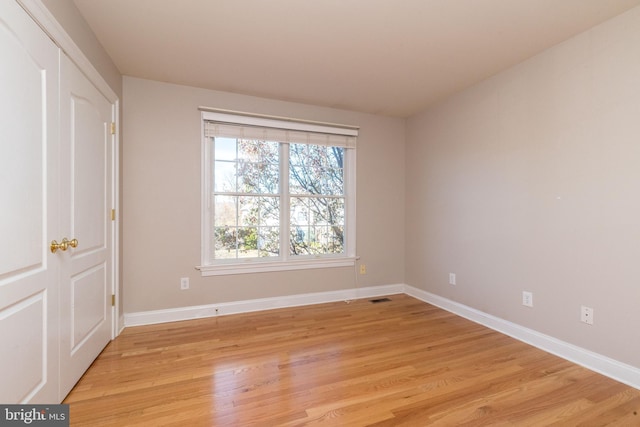 unfurnished room featuring light hardwood / wood-style floors