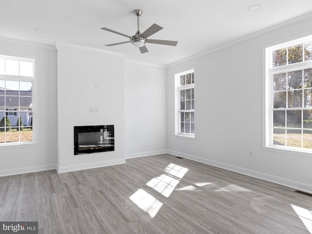 unfurnished living room featuring crown molding, light hardwood / wood-style flooring, and ceiling fan