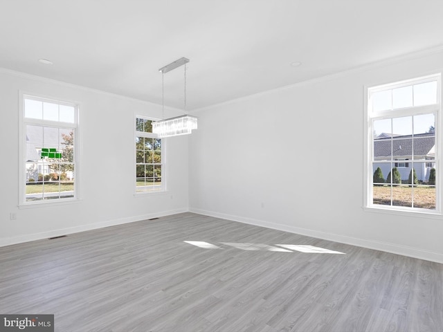 unfurnished room with light hardwood / wood-style flooring, a healthy amount of sunlight, and crown molding