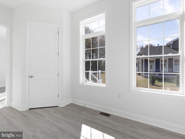 unfurnished room featuring hardwood / wood-style flooring