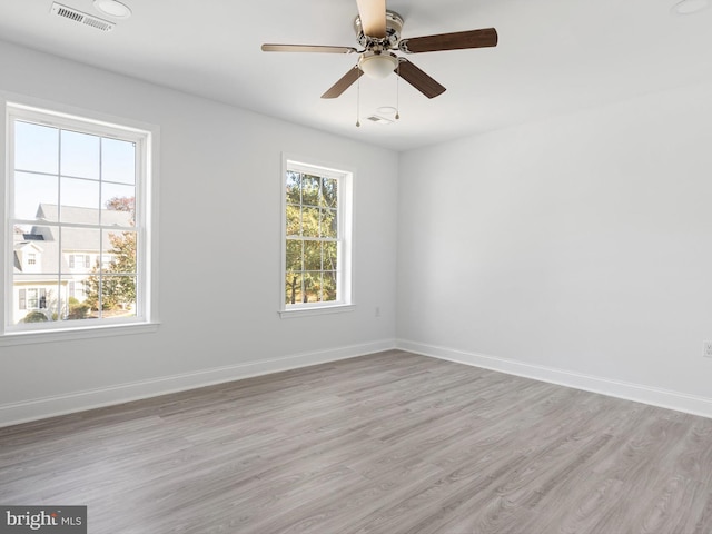 spare room with light hardwood / wood-style floors and ceiling fan