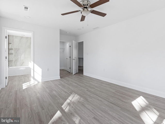 unfurnished bedroom with ensuite bath, light hardwood / wood-style flooring, and ceiling fan