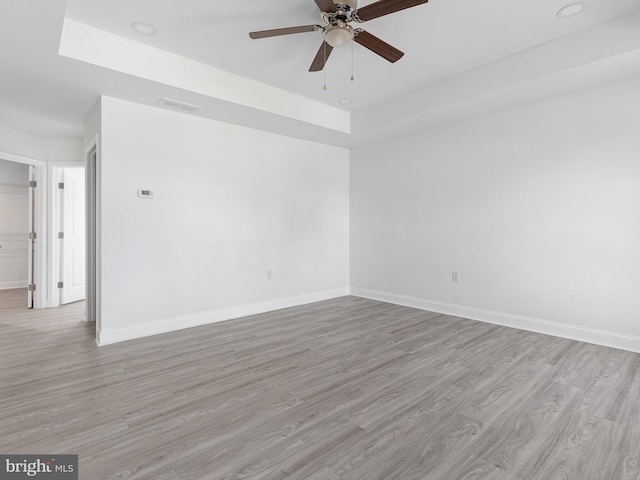 spare room with light wood-type flooring and ceiling fan