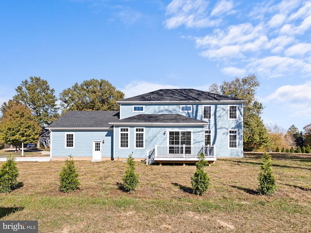 view of front facade featuring a deck and a front lawn