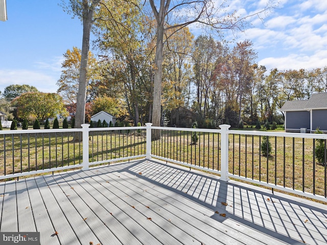 wooden deck with a lawn