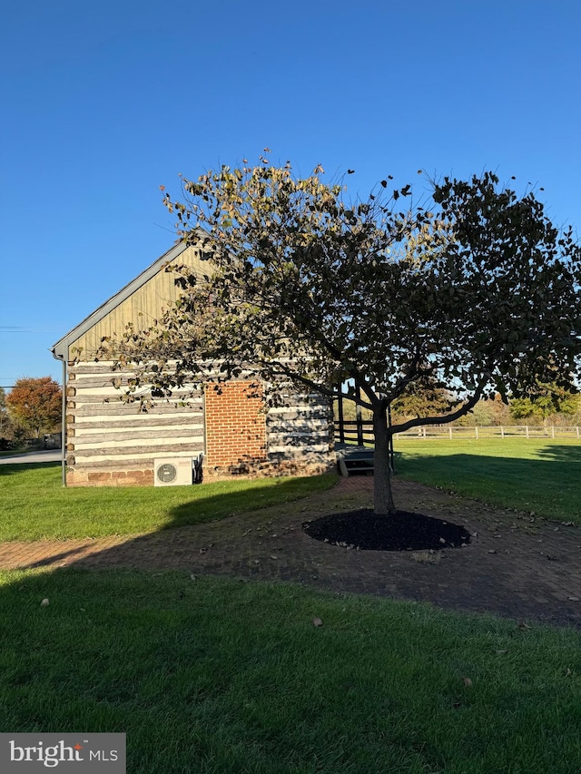 view of side of property featuring a yard