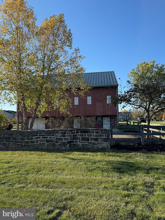 view of property exterior featuring a lawn