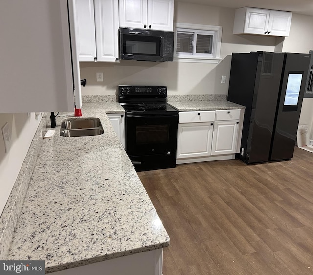 kitchen featuring white cabinetry, sink, light stone counters, dark hardwood / wood-style flooring, and black appliances