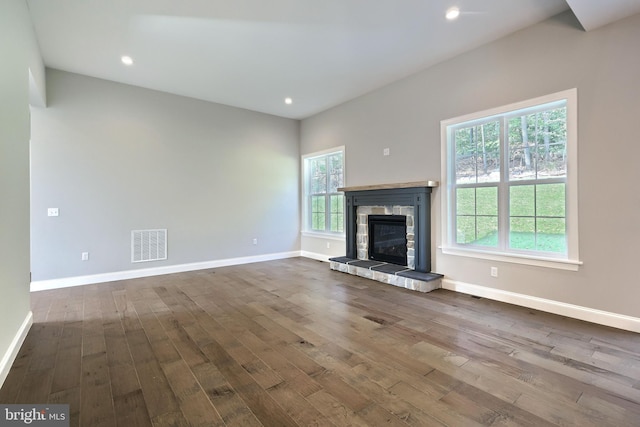 unfurnished living room featuring a fireplace and dark hardwood / wood-style flooring