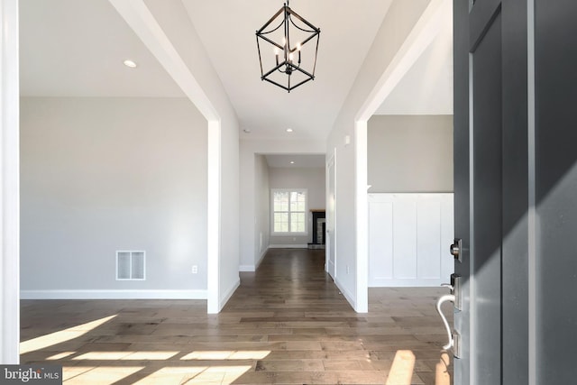 foyer with a chandelier and wood-type flooring