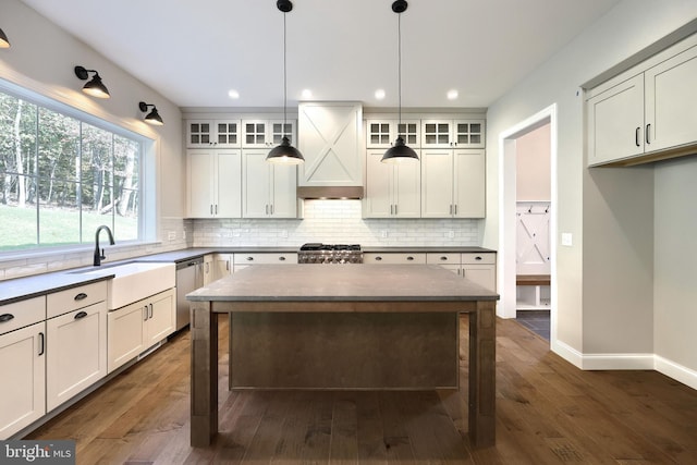 kitchen featuring sink, white cabinetry, a kitchen island, and dark hardwood / wood-style flooring