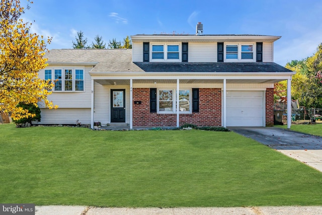 tri-level home featuring a front yard and a garage