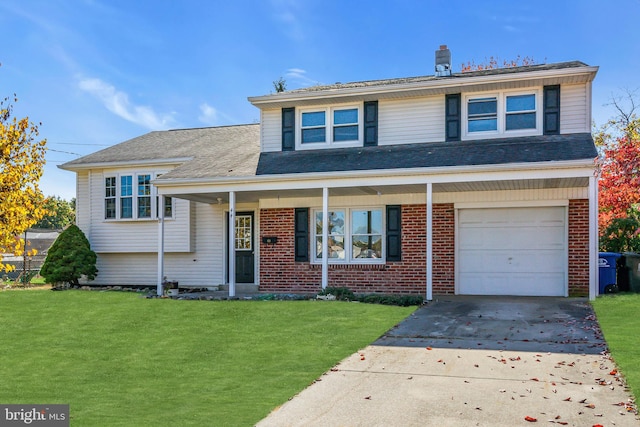 tri-level home featuring a front yard and a garage