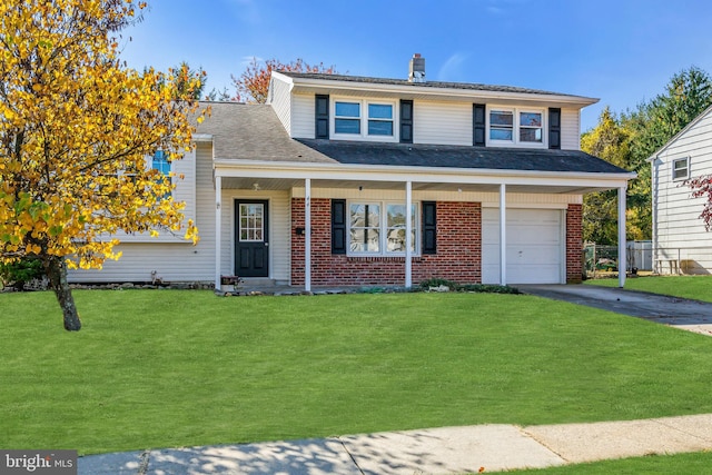 view of front facade with a front yard and a garage