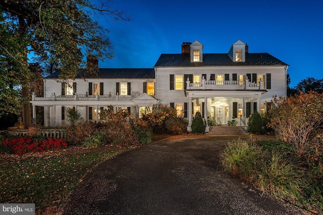 view of front of home with a balcony and a porch