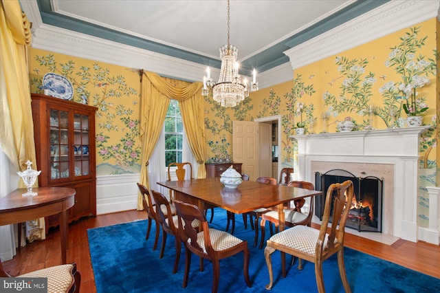 dining room with a notable chandelier, ornamental molding, and dark wood-type flooring